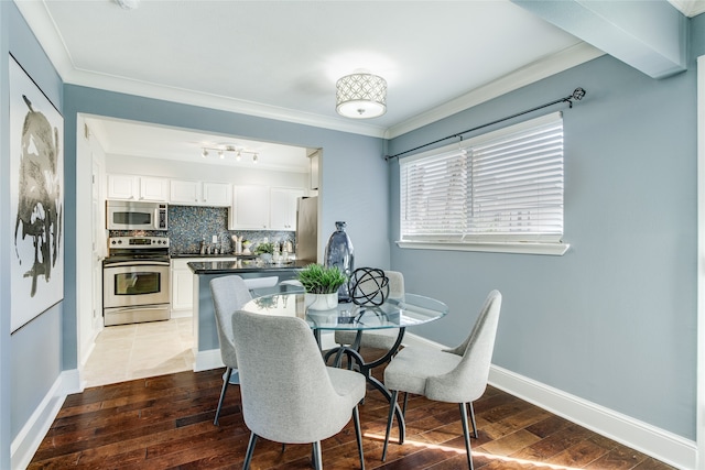 dining space featuring crown molding and dark wood-type flooring