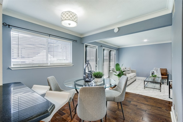 dining area with dark hardwood / wood-style floors and crown molding