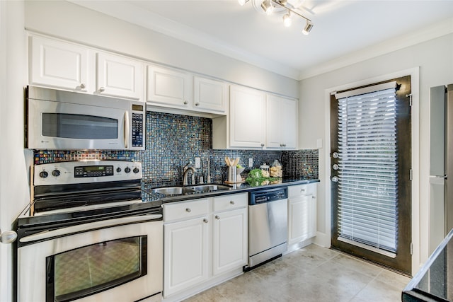 kitchen with white cabinetry, sink, stainless steel appliances, decorative backsplash, and ornamental molding