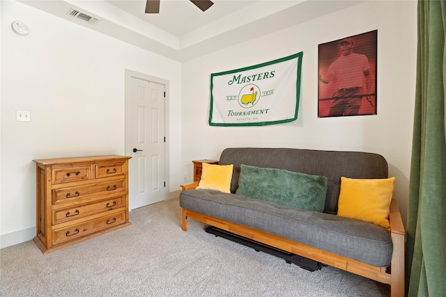 sitting room with light colored carpet, visible vents, and ceiling fan