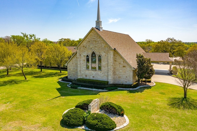 26035 Heartwood Dr Unit 410, Whitney, TX 76692 - exterior space with driveway, a lawn, brick siding, a shingled roof, and stone siding