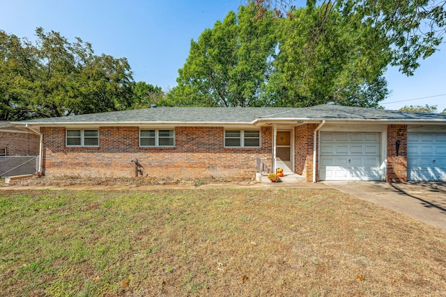 ranch-style home featuring a front lawn and a garage