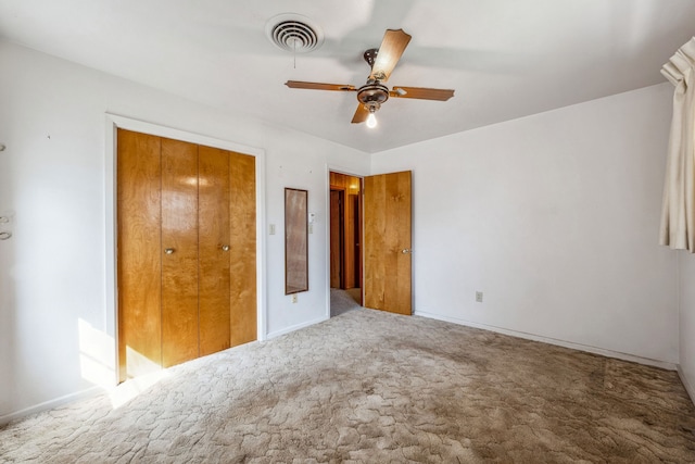 unfurnished bedroom with a closet, carpet flooring, and ceiling fan