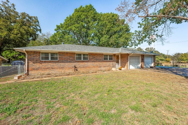 single story home with a front yard and a garage