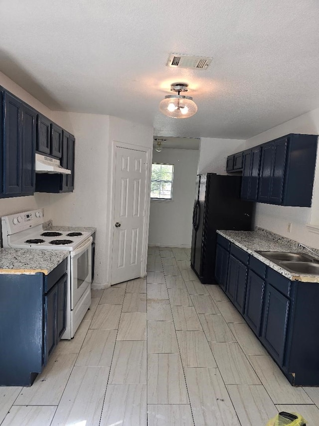 kitchen featuring black refrigerator, sink, blue cabinets, a textured ceiling, and electric stove