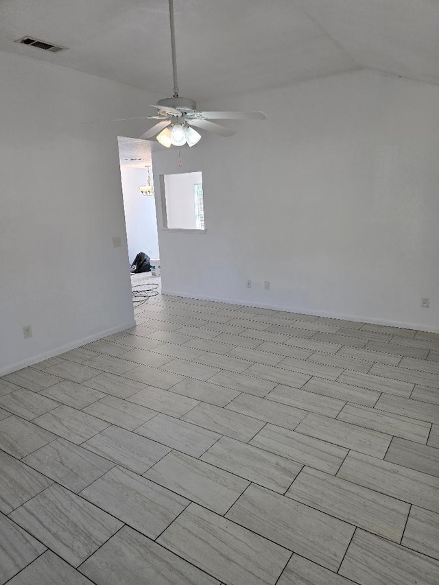 spare room featuring ceiling fan and vaulted ceiling