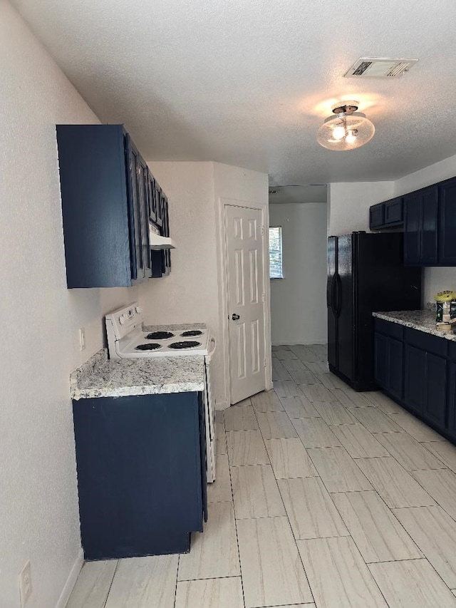 kitchen with black fridge, white range with electric cooktop, blue cabinets, light stone counters, and a textured ceiling