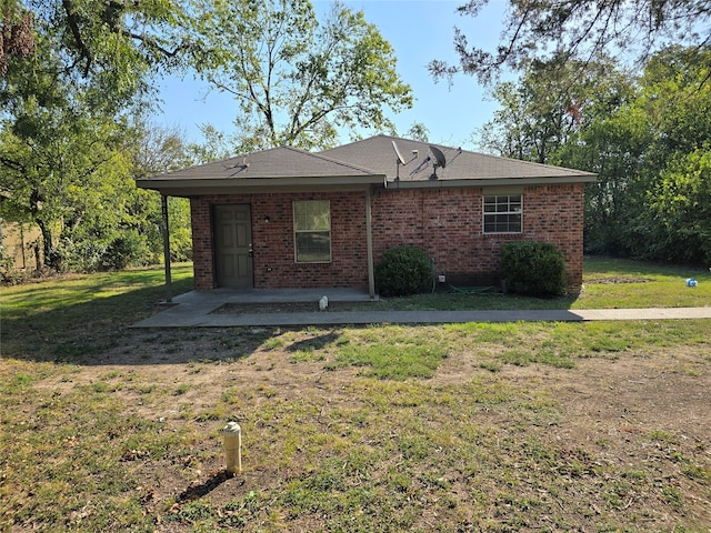 back of house featuring a patio and a yard