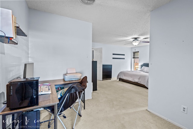 carpeted bedroom with a textured ceiling and ceiling fan