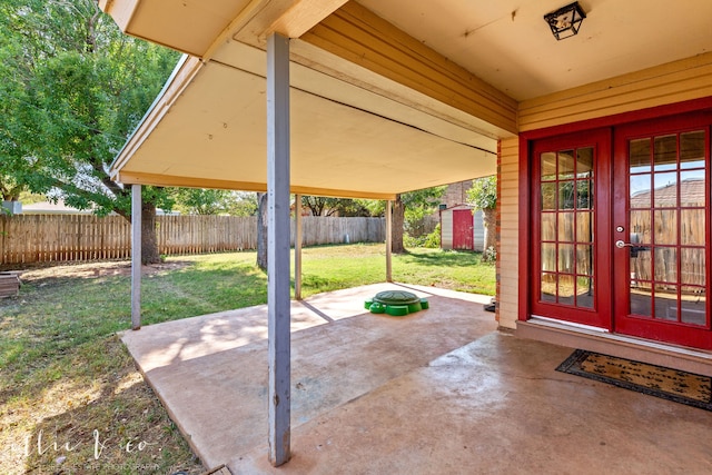 view of patio / terrace with french doors and a shed