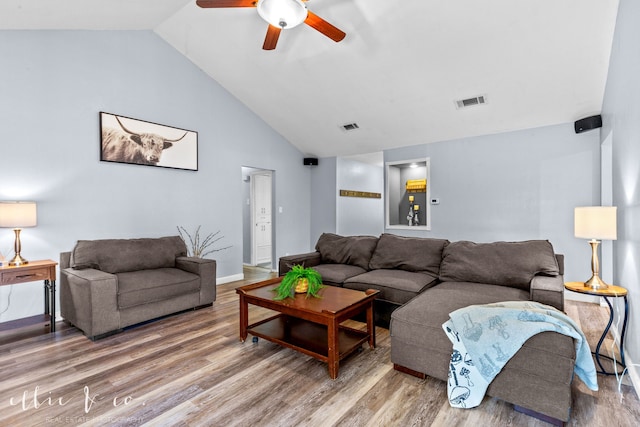 living room with ceiling fan, hardwood / wood-style flooring, and vaulted ceiling