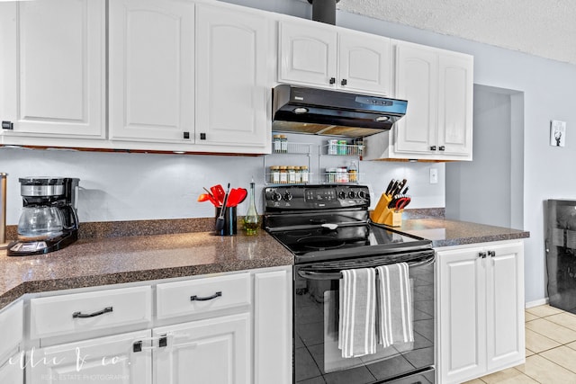 kitchen with a textured ceiling, black electric range oven, light tile patterned floors, and white cabinets