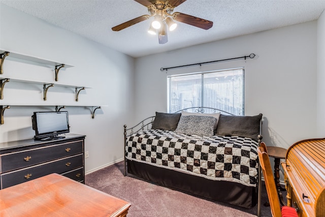 carpeted bedroom featuring a textured ceiling and ceiling fan