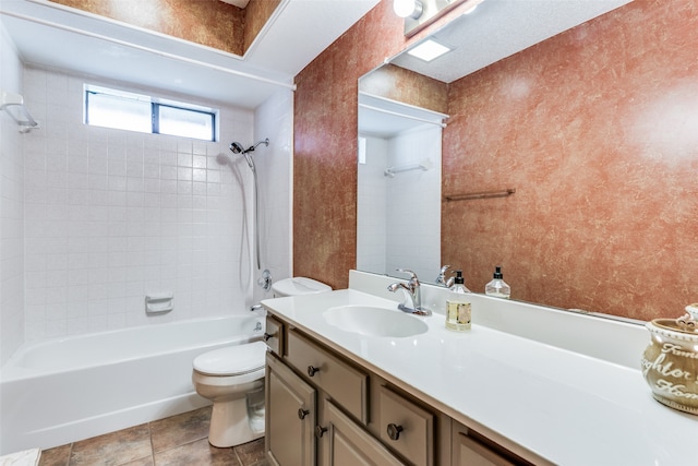 full bathroom with toilet, tiled shower / bath, vanity, and tile patterned flooring