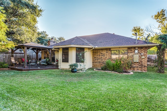 back of house featuring a gazebo and a yard