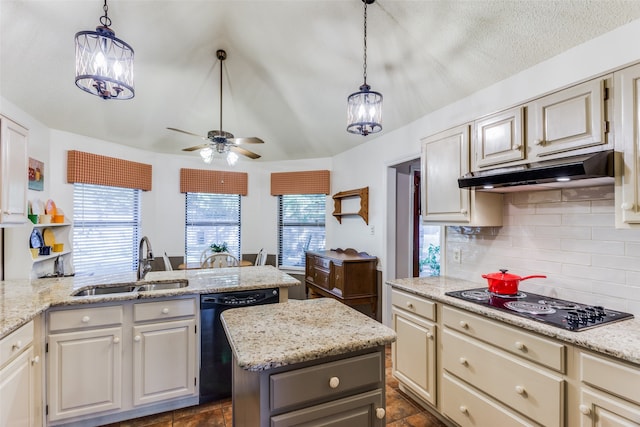 kitchen featuring sink, a center island, decorative light fixtures, and black appliances