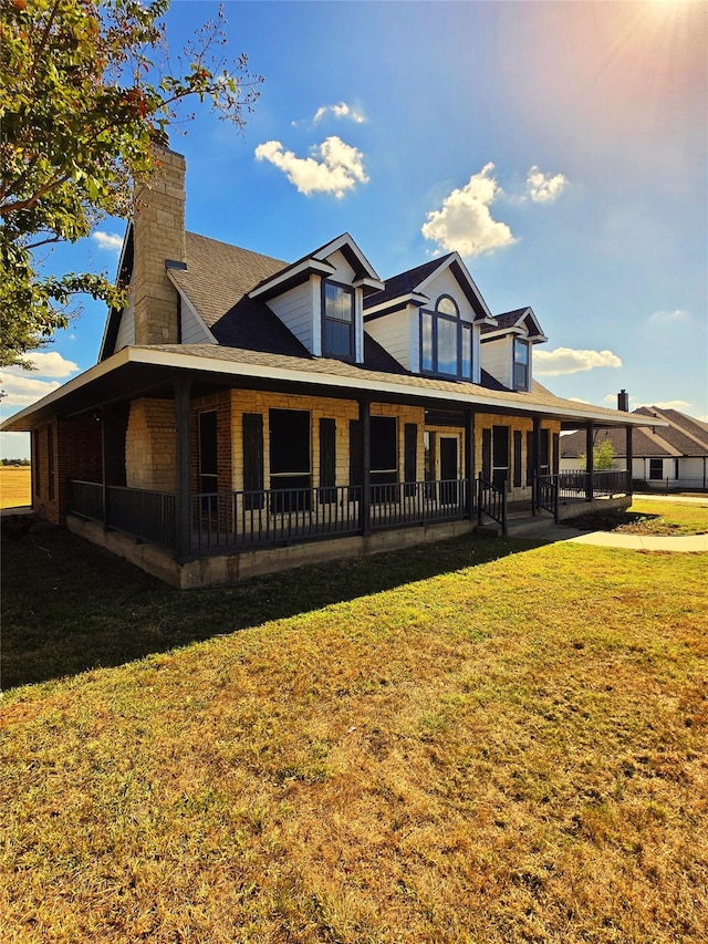 back of house with a lawn and a porch