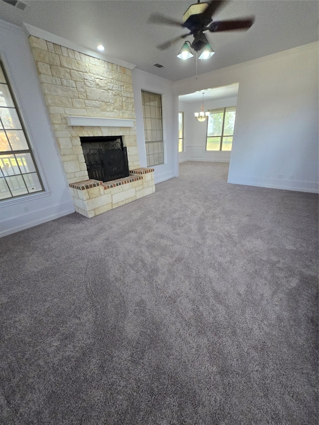 unfurnished living room with crown molding, a fireplace, carpet floors, and ceiling fan with notable chandelier