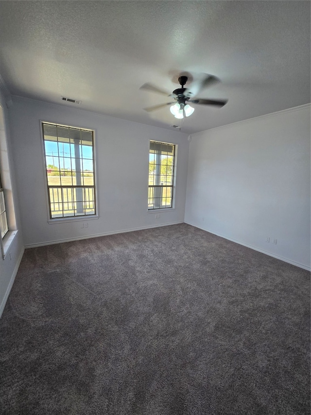 carpeted spare room with a textured ceiling and ceiling fan