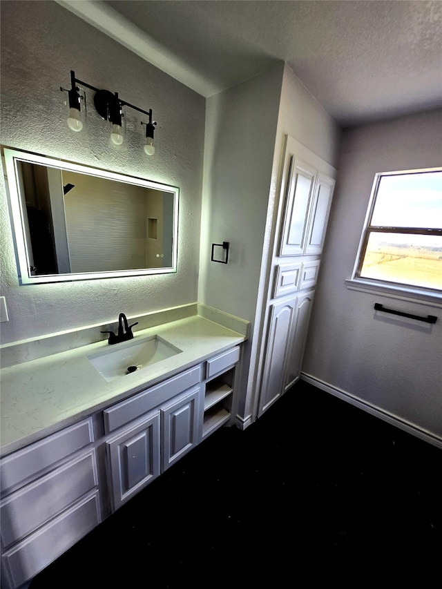 bathroom with vanity and a textured ceiling