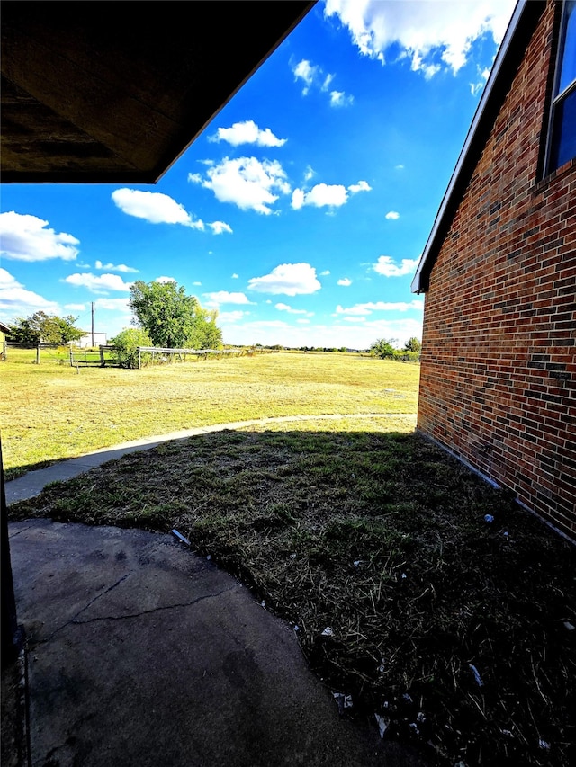 view of yard with a patio area and a rural view