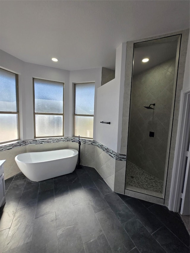 16536 County Road 221, Forney, TX 75126 - bathroom featuring vanity, independent shower and bath, and tile walls