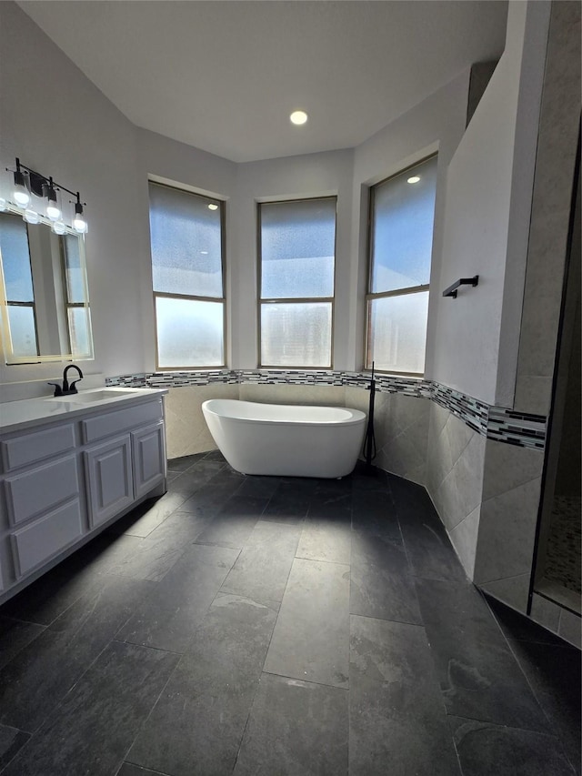 16536 County Road 221, Forney, TX 75126 - bathroom featuring vanity, tile walls, and a bathtub