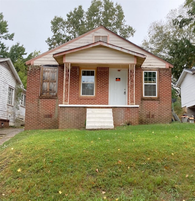 bungalow-style home featuring a front yard