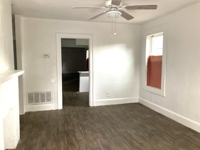 empty room featuring dark wood-type flooring and ceiling fan