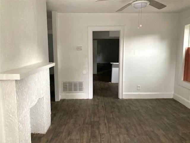 spare room featuring dark wood-type flooring and ceiling fan