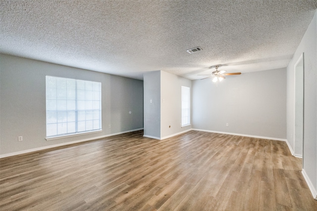 unfurnished room with light hardwood / wood-style flooring, a textured ceiling, and ceiling fan