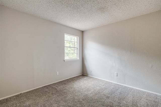 carpeted spare room featuring a textured ceiling