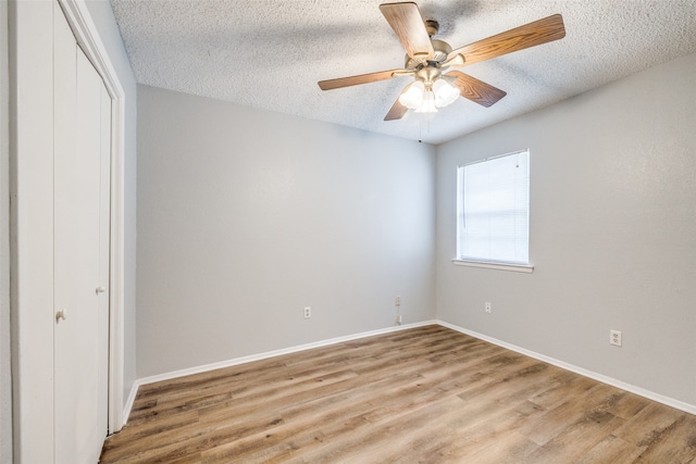 unfurnished bedroom with a closet, ceiling fan, a textured ceiling, and light hardwood / wood-style floors