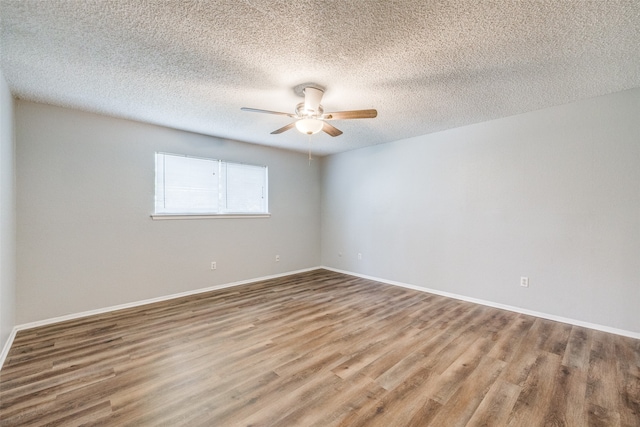 empty room featuring a textured ceiling, hardwood / wood-style flooring, and ceiling fan