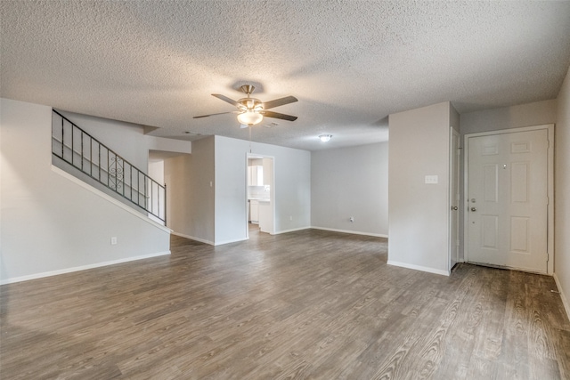 unfurnished living room featuring ceiling fan, a textured ceiling, and hardwood / wood-style floors