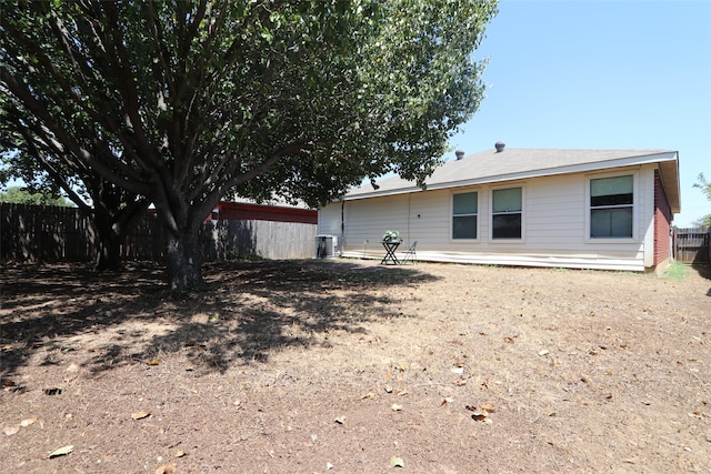 rear view of property with central AC