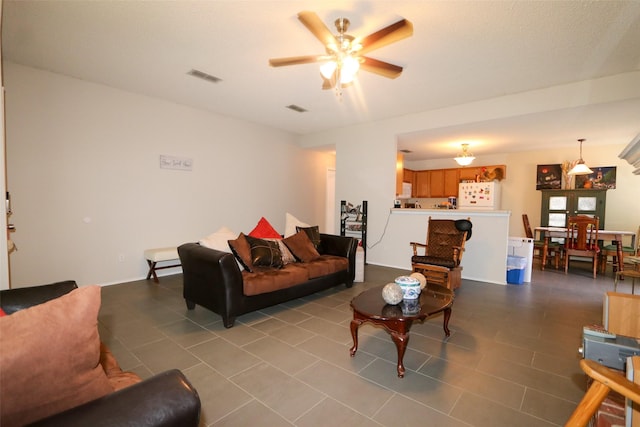 tiled living room with ceiling fan