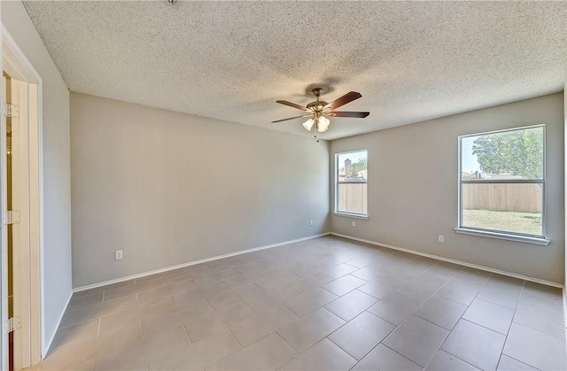 unfurnished room featuring light tile patterned floors, a textured ceiling, and ceiling fan