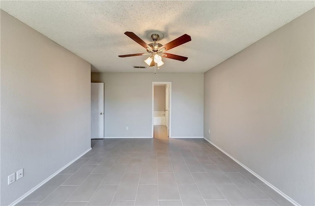 spare room with a textured ceiling and ceiling fan