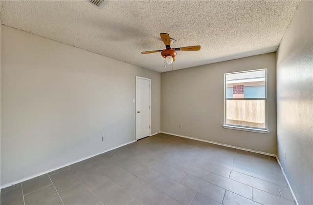 spare room with a textured ceiling and ceiling fan