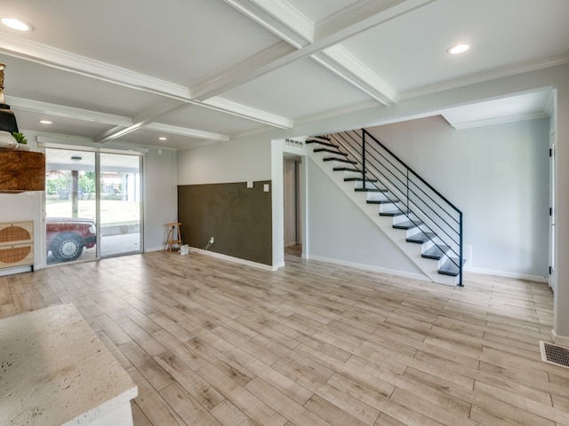 interior space with coffered ceiling, beam ceiling, ornamental molding, and light hardwood / wood-style flooring