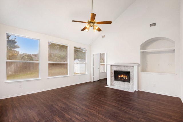 unfurnished living room with dark wood-type flooring, ceiling fan, and high vaulted ceiling