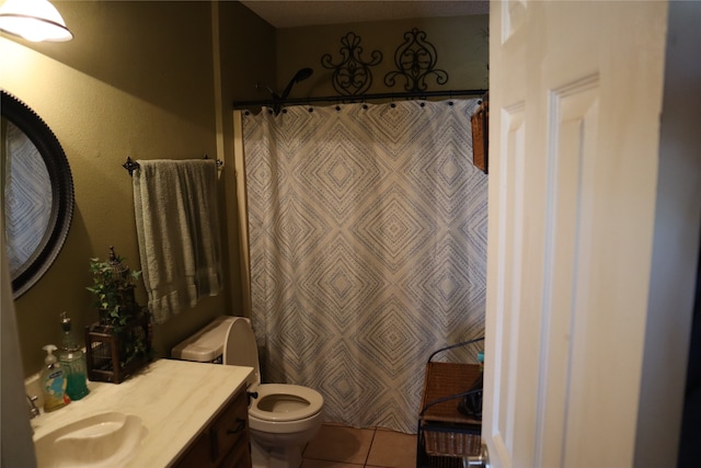 bathroom with tile patterned floors, walk in shower, vanity, and toilet