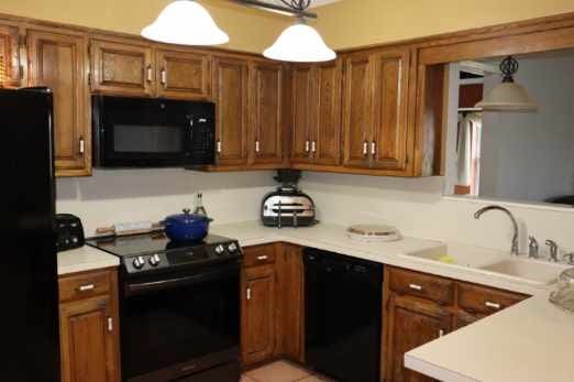 kitchen featuring pendant lighting, sink, and black appliances