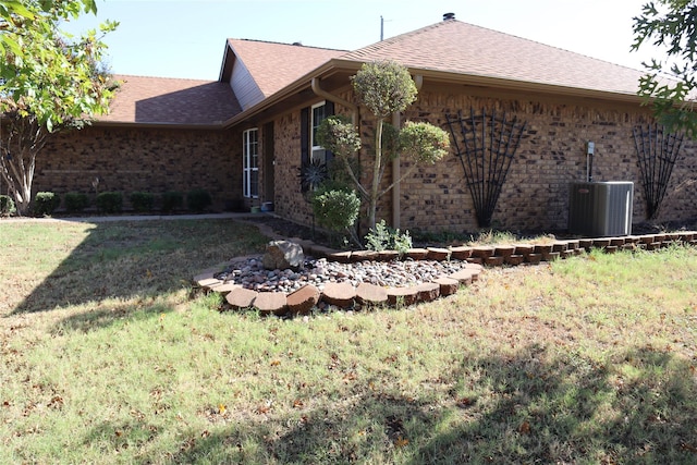 exterior space with a yard and central air condition unit