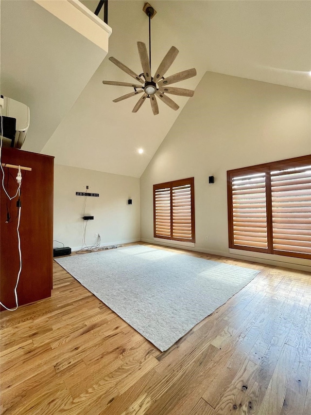 interior space featuring light hardwood / wood-style floors, high vaulted ceiling, and ceiling fan