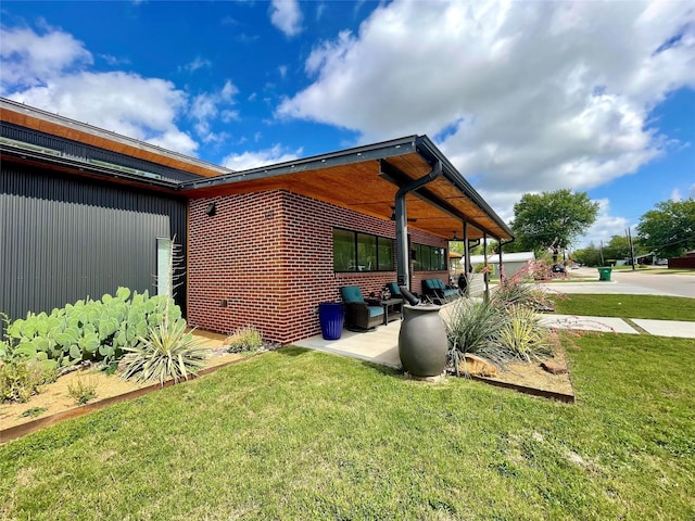 exterior space with a patio and a lawn