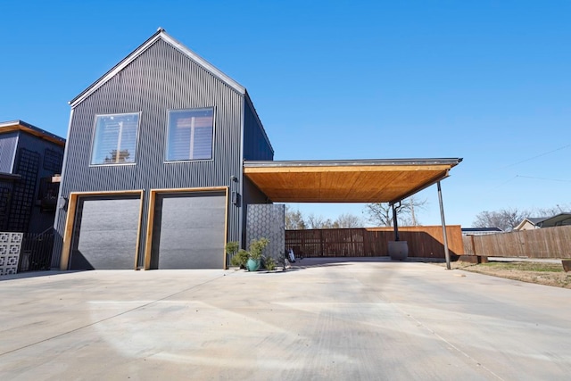 view of front of home with a garage and a carport