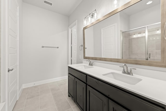 bathroom with vanity, tile patterned flooring, and a shower with door