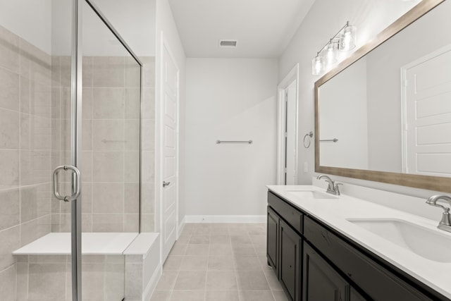 bathroom with tile patterned flooring, an enclosed shower, and vanity